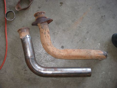1995 Ford Bronco - Comparison of a rusty exhaust pipe with a newly fabricated one, likely for a vehicle repair.