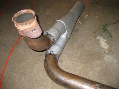 1995 Ford Bronco - A custom exhaust Y-pipe assembly is shown, a rusty flange and freshly welded sections.