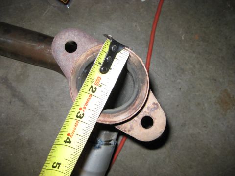 1995 Ford Bronco - Measuring an exhaust pipe flange with a tape measure.
