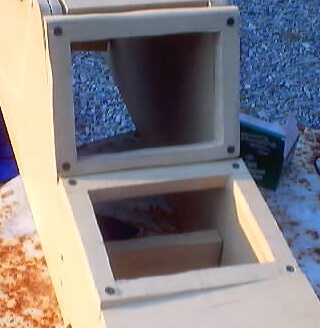 1999 Ford Taurus - A wooden insert with two open compartments sits on a surface.
