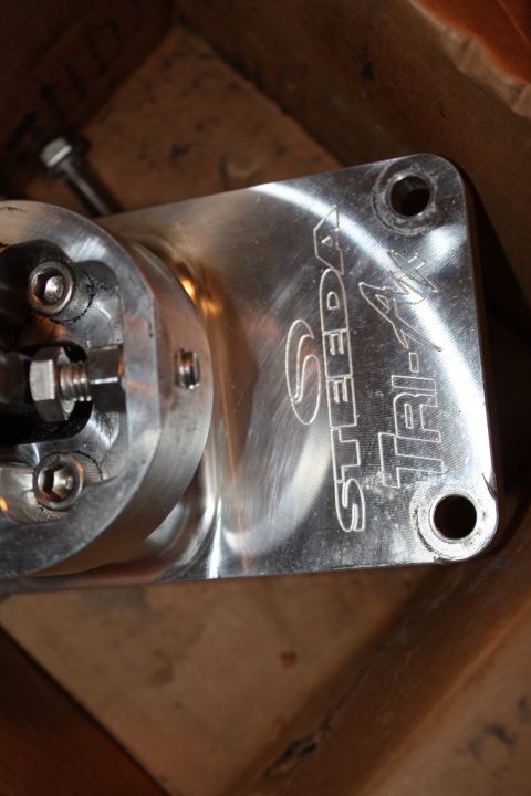 2004 Ford Mustang - Close-up of a Steeda Tri-Ax shifter part, likely for a manual transmission vehicle.