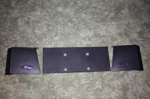 2004 Ford Mustang - Ford GT emblems and license plate bracket are displayed on a textured background.