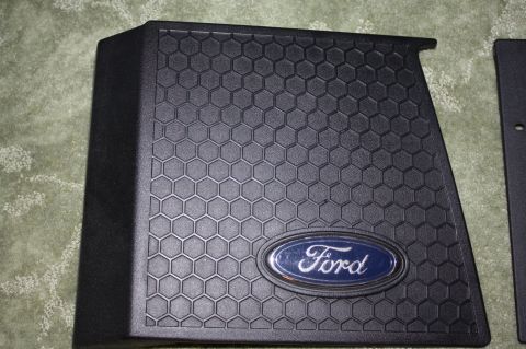 2004 Ford Mustang - This part features the iconic Ford oval emblem set against a hexagonal textured surface.