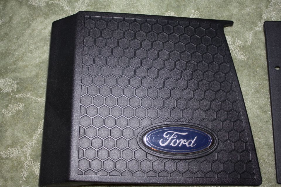 Black textured part with Ford oval emblem