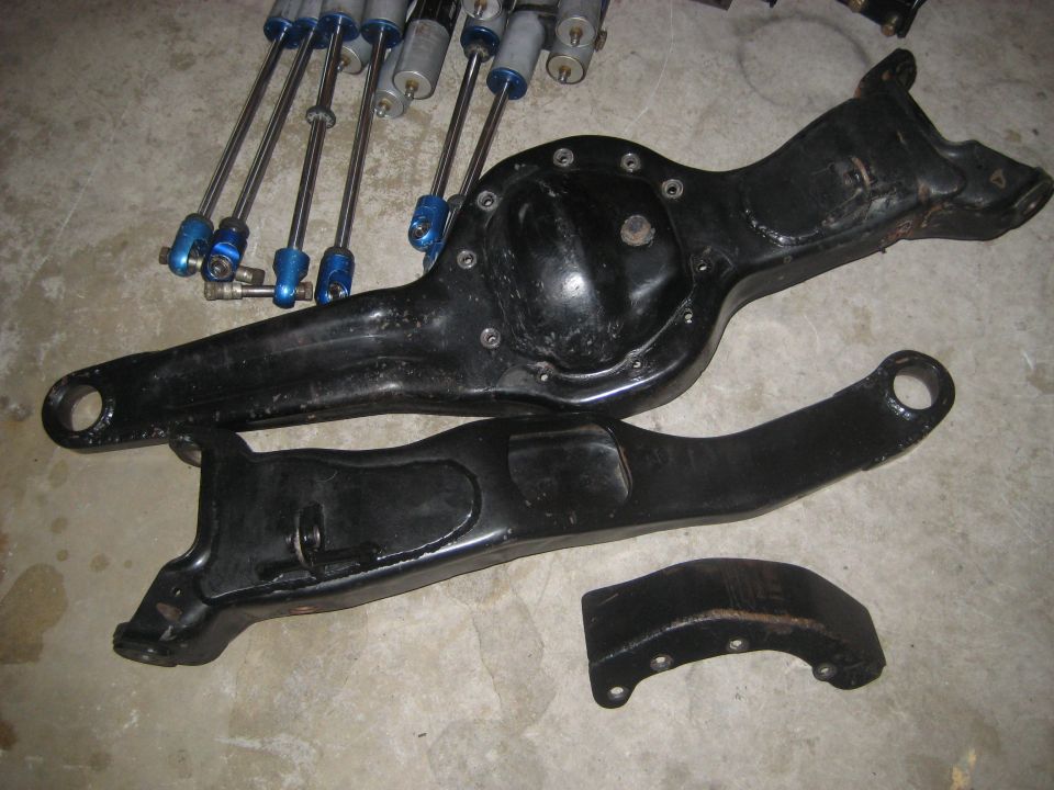 Ford Bronco front suspension parts and shocks on concrete floor