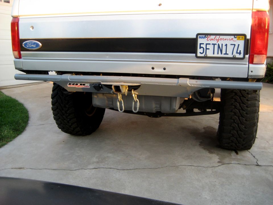 Silver 1996 Ford Bronco rear with aftermarket bumper, hitch, and California license plate 5FTN174