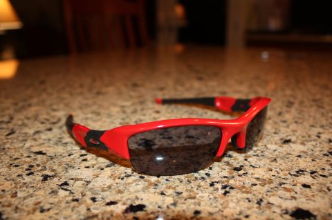 2004 Ford Mustang - A pair of red Oakley sunglasses rests on a granite countertop.