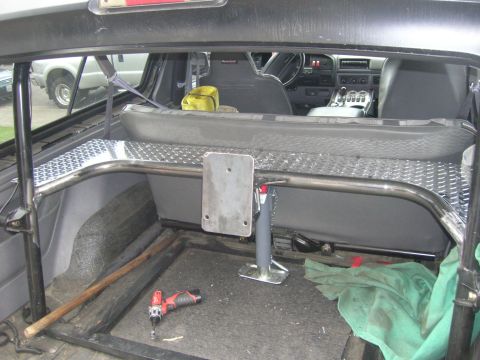 1996 Ford Bronco - The interior of a 1996 Ford Bronco features a custom roll cage and diamond plate flooring.