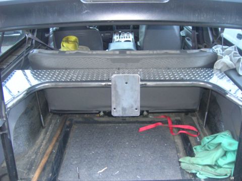 1996 Ford Bronco - The interior cargo area of a 1996 Ford Bronco shows a custom spare tire mount and diamond plate trim.