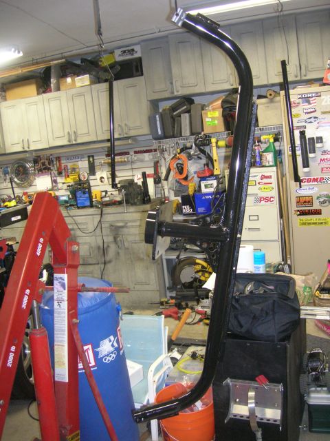 1996 Ford Bronco - Spare tire mount assembly is shown in a cluttered garage environment.