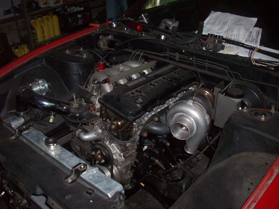 Turbocharged engine bay with custom intake and exhaust piping