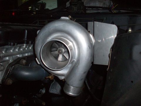 1992 Nissan 240SX - Close-up of a turbocharger, a component used to increase engine power.