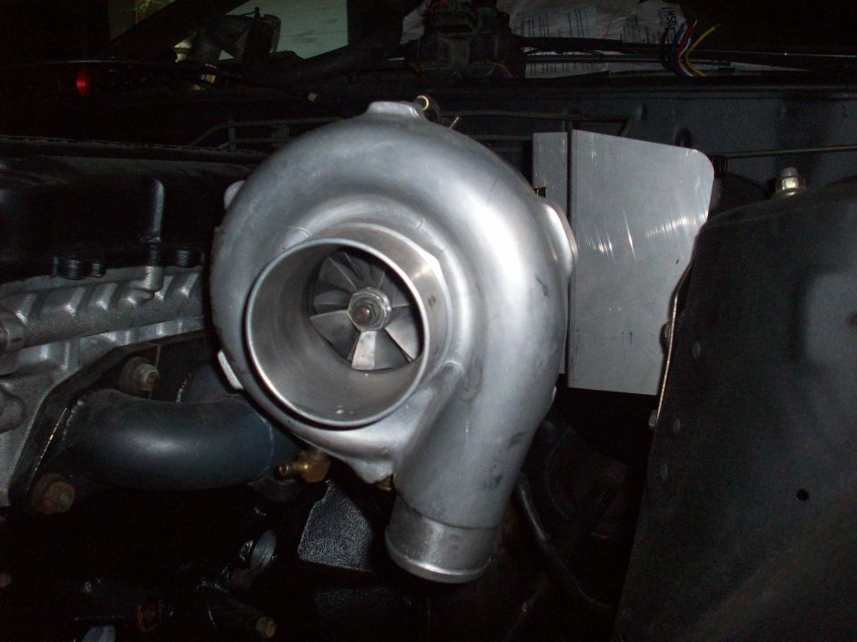 Turbocharger mounted in engine bay, likely for performance upgrade