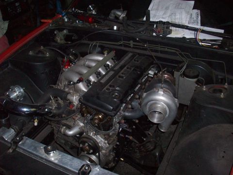 1992 Nissan 240SX - Engine bay with a turbocharger and custom piping, suggesting performance modifications.