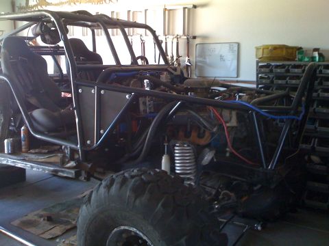 1966 Ford Bronco - This custom-built buggy is in a garage, showing its internal structure and engine components.