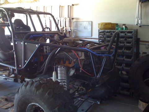 1966 Ford Bronco - Custom buggy frame in garage, showing engine and roll cage construction.