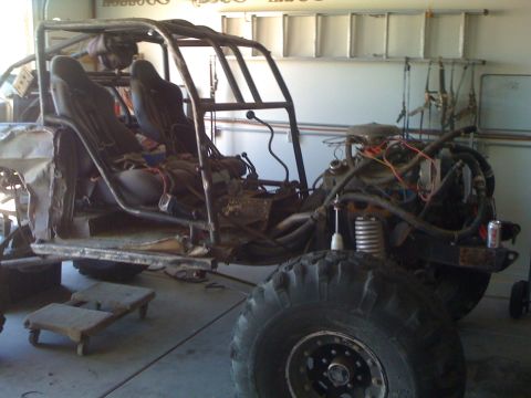 1966 Ford Bronco - This custom-built buggy is in a state of assembly, a roll cage, engine, and large off-road tires.