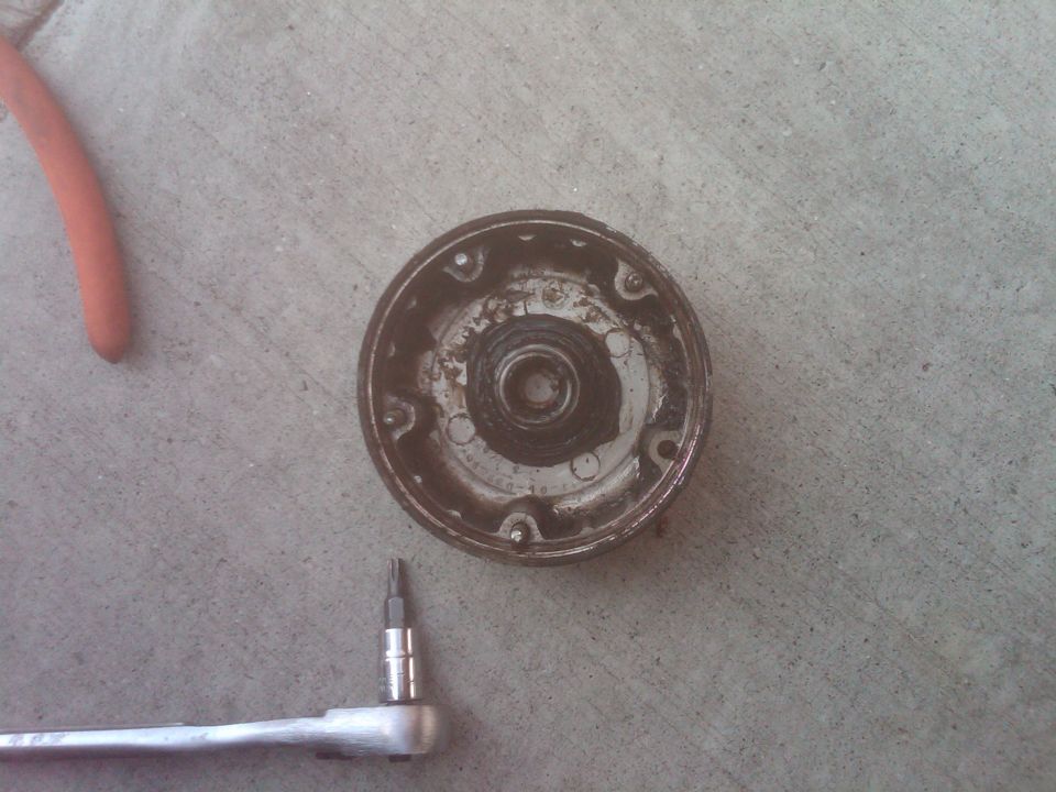 Distributor cap and rotor removed, with a ratchet and hex bit tool on concrete