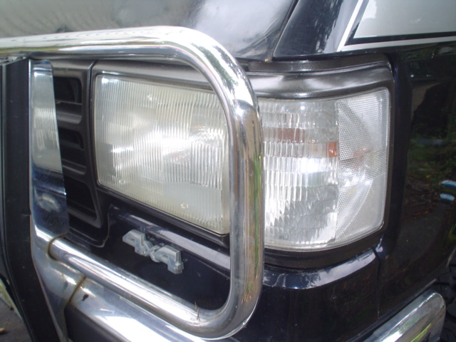Black Ford Bronco front end with chrome bull bar, showing headlights and a "4x4" badge