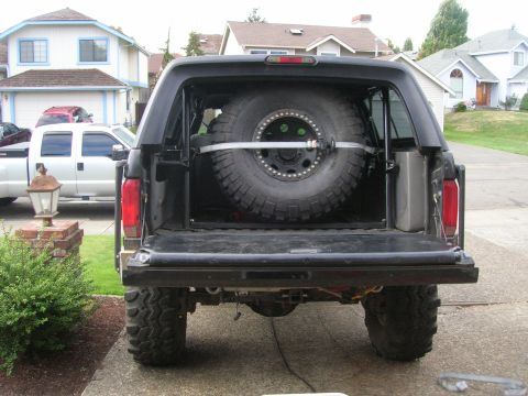 1996 Ford Bronco - Rear view of a 1996 Ford Bronco showing the interior spare tire mount and tailgate.
