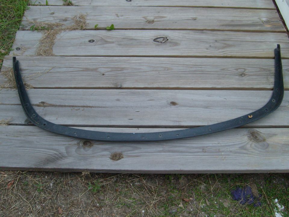 Curved black trim piece with mounting holes