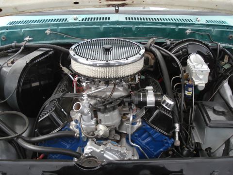 1979 Ford F-150 - Engine bay of a 1979 Ford F-150, a prominent chrome air cleaner and bright blue valve covers.