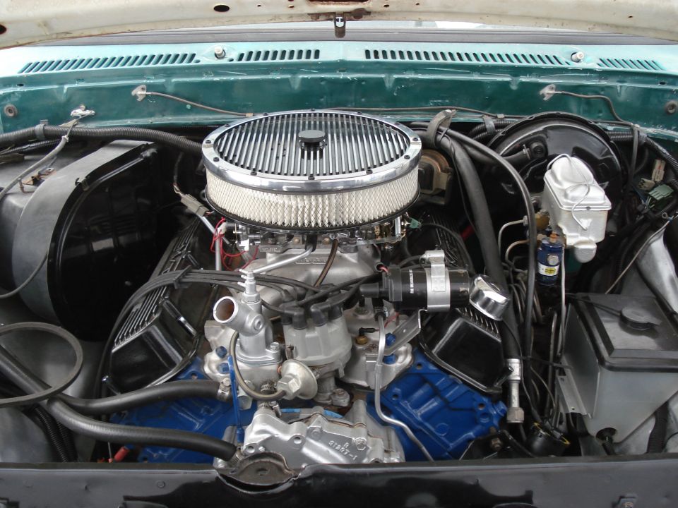 1979 Ford F-150 engine bay with chrome air cleaner and blue valve covers