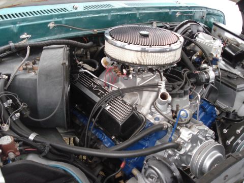 1979 Ford F-150 - The engine bay of a vehicle, a V8 engine with aftermarket valve covers and air intake.