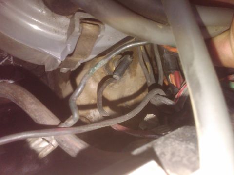 1982 Ford Bronco - A tangled mess of wires and hoses is visible in this engine bay shot.