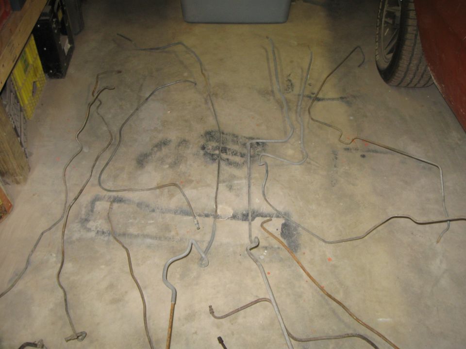 Metal brake lines scattered on a concrete floor