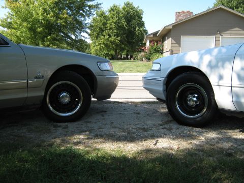 2000 Mercury Grand Marquis - Two 2000 Mercury Grand Marquis sedans are parked next to each other, showing their front ends.