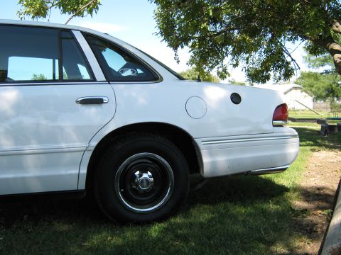 2000 Mercury Grand Marquis - This white sedan is parked on a grassy area with a tree overhead. The rear passenger side is visible.