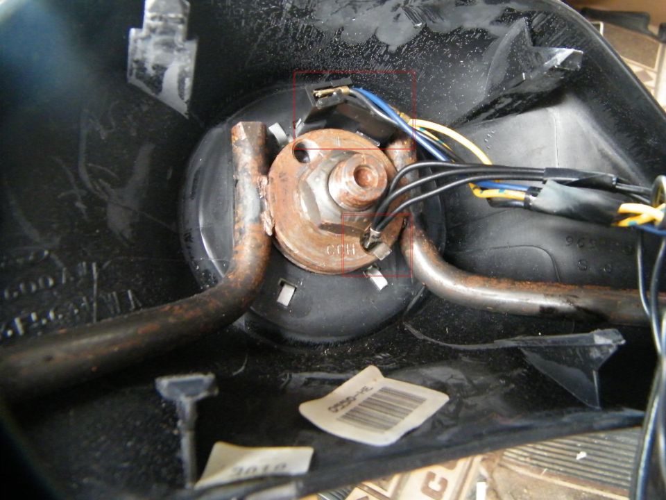 TURN SIGNAL SWITCH / TILT WHEEL
My turn signal switch/tilt wheel broke a few months ago.  The lever was real loose, I'd push back for the tilt and I could feel the play as the lever hit the tilt bar and would give way...the switch inside was loose or broke.  So the tilt wheel was stuck in my "drive" position - great for getting in/out - and the turn signal lever would not snap back to the off position after completing a turn.  After banging my knees a few times, it's time to take a look.  Bottom side of wheel - remove the two screws and take off the front of the steering wheel.  It will look like the pic above.  Two wires to remove first.  The single black line is the ground, and it's in the hole with a spring clip.  Squeeze and pull.  The wires at top are the cruise control.  It's really one long plug, so grab at either side and start to tug off.