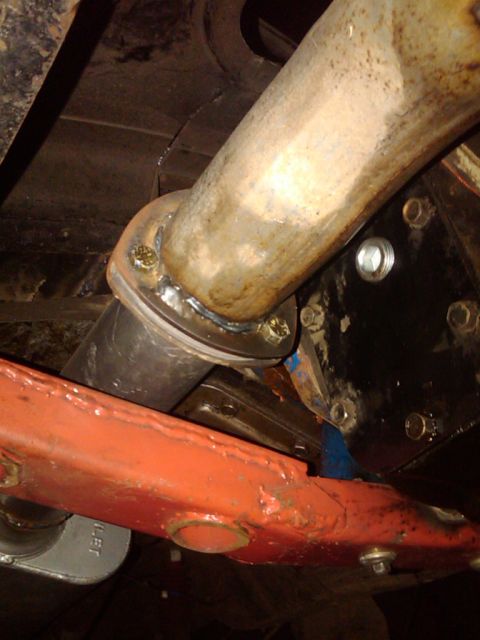 1978 Ford Bronco - Close-up view of vehicle undercarriage components, focusing on the exhaust system and suspension.