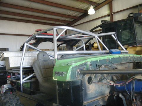 1978 Ford Bronco - A custom roll cage is installed over the interior of a modified vehicle, with a toolbox visible in the background.