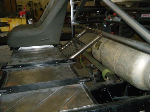 1978 Ford Bronco - Interior view of a modified off-road vehicle, a roll cage and fuel tank.