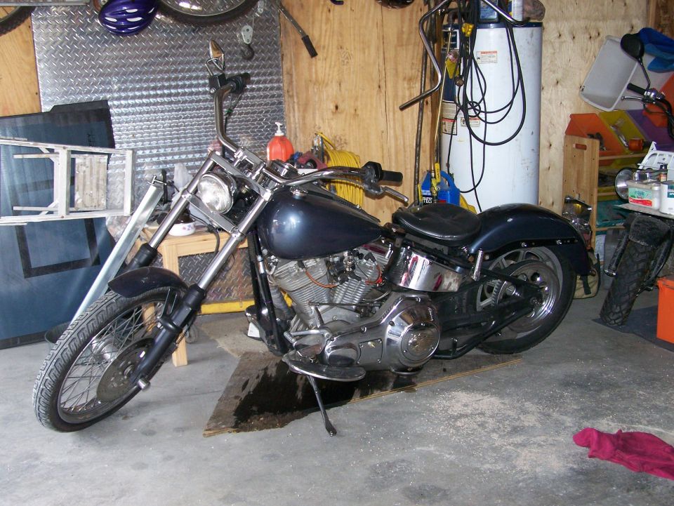 Dark blue motorcycle with chrome accents parked in a garage