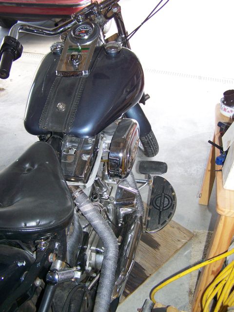 1988 Suzuki Samurai - A dark blue motorcycle is shown from the side, a black seat and prominent chrome details on the engine and handlebars.