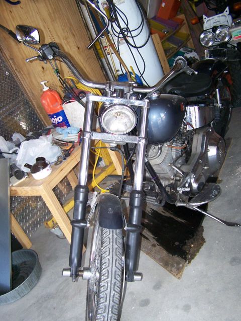 1988 Suzuki Samurai - A motorcycle is parked in a garage with various items in the background.