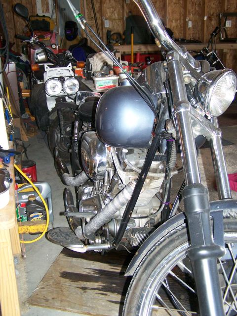 1988 Suzuki Samurai - A motorcycle is parked in a garage, with another motorcycle partially visible behind it.