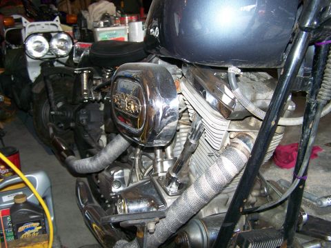 1988 Suzuki Samurai - Close-up view of a motorcycle's engine and front section, showing custom exhaust and chrome details.