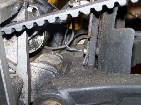 1988 Suzuki Samurai - Close-up view of engine components, including a timing belt and pulleys, covered in dust.