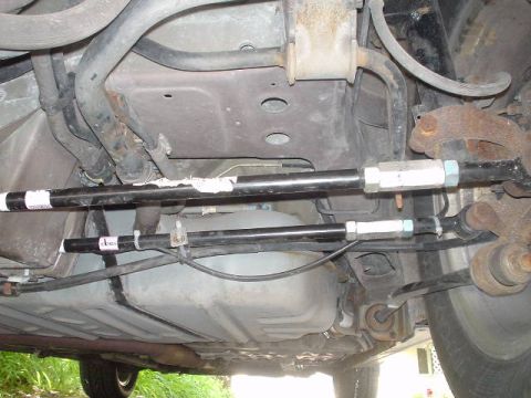 1999 Ford Taurus - The photo shows the underside of a vehicle, focusing on the rear suspension and fuel tank components.