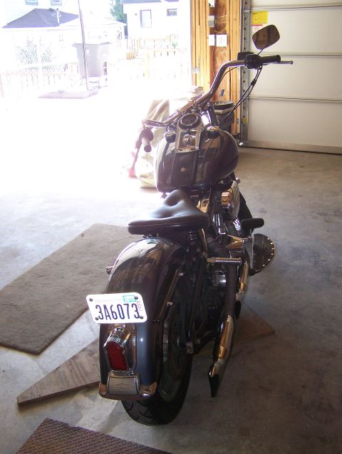 1988 Suzuki Samurai - Motorcycle parked in a garage, showing its rear fender, taillight, and license plate.