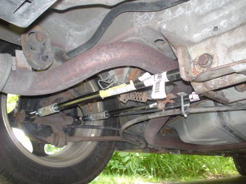1999 Ford Taurus - The underside of a vehicle is captured, revealing suspension parts and the exhaust system.