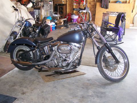 1988 Suzuki Samurai - Two motorcycles are parked inside a garage, one in the foreground and another behind it.