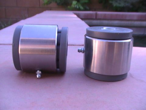 1997 Ford Ranger - Two cylindrical parts, possibly bearings or bushings, are shown outdoors.