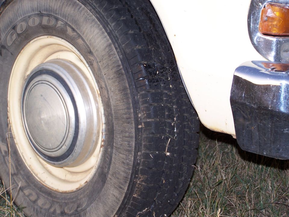 Close-up of a tire and hubcap on a white vehicle