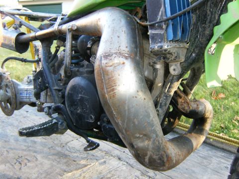 2000 Ford E350 - Close-up of a dirt bike's engine and exhaust system, showing mechanical components and frame structure.