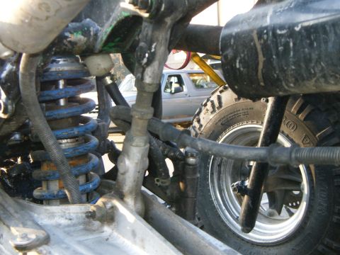 2000 Ford E350 - The foreground shows a vehicle's suspension and tire, with another vehicle partially visible behind it.